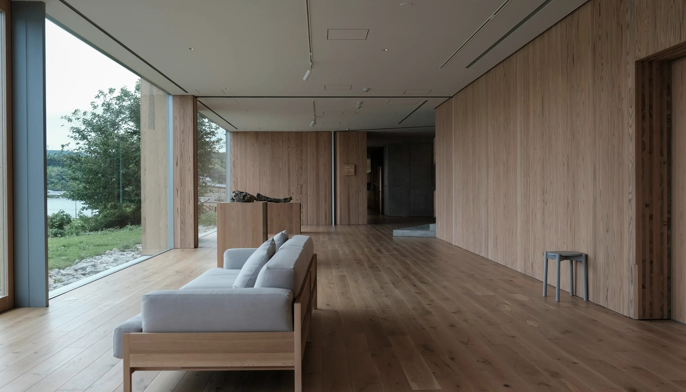 An oak-lined living room opening to a distant view