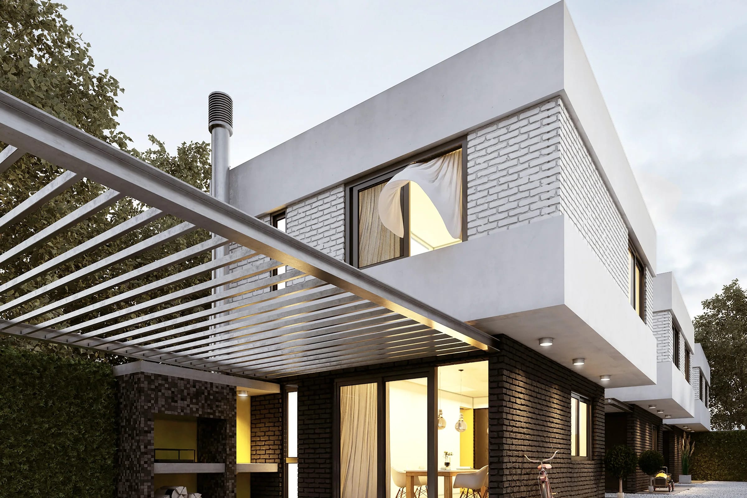 A timber and glass house glowing from within at evening